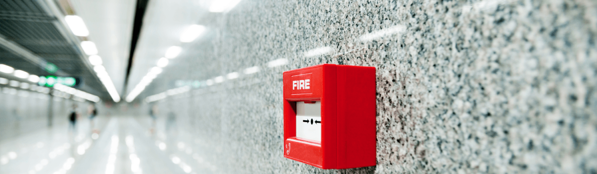 A red fire alarm on a wall
